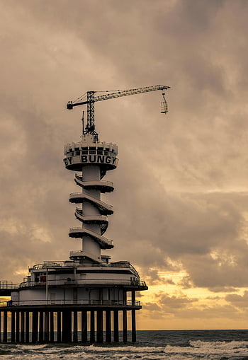 Scheveningen Pier, North Sea, moody sky, tower crane, body of water, dramatic capture, gray and white, coastal structure, bungee jumping, pier architecture, sunset scene