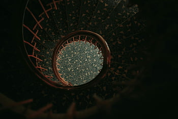 spiral stairs, top view, geometric patterns, staircase design, architectural photography, intricate patterns, spiral staircase photography, mesmerizing design, architectural elements.