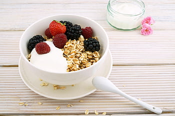 granola bowl, fresh berries, yogurt, healthy breakfast, white ceramic bowl, strawberries, raspberries, blackberries, oatmeal, spoon, yogurt bowl
