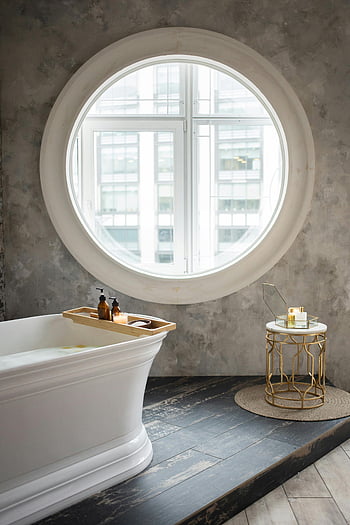 modern bathroom, round window, freestanding tub, elegant decor, luxurious bathroom, interior design, contemporary bathroom, bathroom design, bathroom decor, bathroom window, bathroom furniture