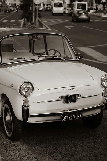 Autobianchi, vintage car, sepia-toned, city street, parked, quiet street, classic car, retro, urban scene, automobile, Italy