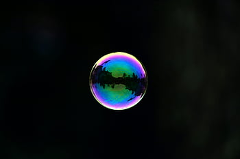 soap bubble, reflection, colorful, natural landscape, dark background, captivating image, bubble reflection, landscape reflection, dark backdrop, iridescent bubble, nature reflection