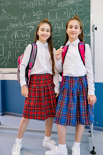 schoolgirls, white long sleeve shirt, plaid uniforms, white sneakers, backpacks, classroom, chalkboard, smiling, school uniform, education, students