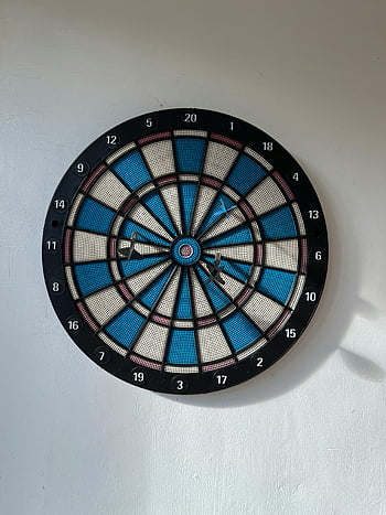 dartboard, darts, white wall, accurately thrown, hanging dartboard, three darts, target practice, recreational activity, indoor game, sports equipment, wall-mounted dartboard