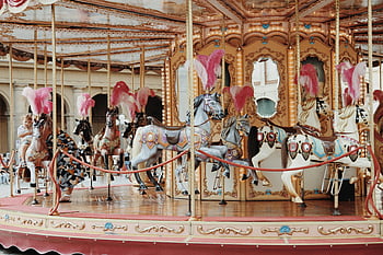 carousel, vintage carousel, ornate horse figures, fairground setting, beautifully decorated, child riding carousel, horse carousel, amusement park ride, vintage amusement ride, fairground attraction, vintage horse carousel