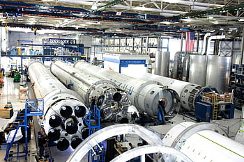 rocket factory, spacecraft assembly line, rockets, spacious hangar, industrial facility, aerospace manufacturing, rocket production, hangar interior, assembly process, space technology, engineering facility