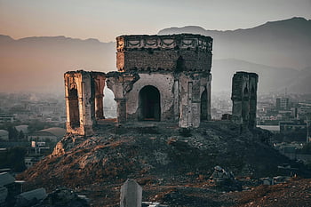 King Nader Shah's tomb, aged ruins, Kabul city, dusk, rich history, hilltop ruins, historical architecture, Afghan landmarks, urban backdrop, ancient structure, sunset scenery