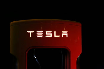 tesla, σταθμός ανεφοδιασμού, φωτεινό κείμενο, μαύρο φόντο, σύγχρονη τεχνολογία αυτοκινήτων, νυχτερινή φωτογραφία, ηλεκτρικό όχημα, πλάγια όψη, καινοτομία αυτοκινήτων, βιώσιμη τεχνολογία, φιλική προς το περιβάλλον μεταφορά