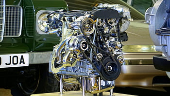 Chrome engine, black engine, polished engine, car engine, exhibition display, detailed view, engine components, automotive display, mechanical parts, engine belts, engine pulleys