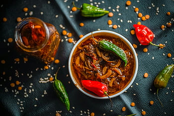 spicy food, Bangladeshi flavors, homemade pickle, fresh chilies, aromatic spices, vibrant bowl, close-up shot, tasty food, spicy dish, red chilies, green chilies