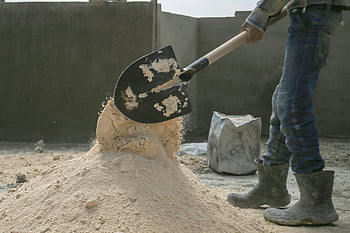 construction site, man working, shovel, laborer, shoveling sand, Latakia, Syria, construction worker, building site, sand pile, work boots
