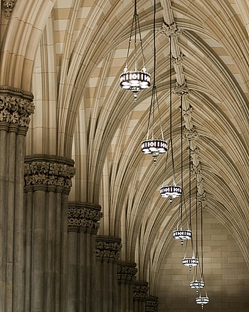 gray pendant lights, gothic archway, detailed architecture, hanging lights, New York cathedral, elegant design, interior lighting, cathedral ceiling, gothic style, chandelier, religious architecture