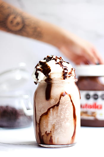 chocolate milkshake, whipped cream, drizzled chocolate syrup, indulgent dessert, glass of milkshake, chocolate topping, creamy milkshake, chocolate drizzle, milkshake with chocolate, Nutella, mason jar drink