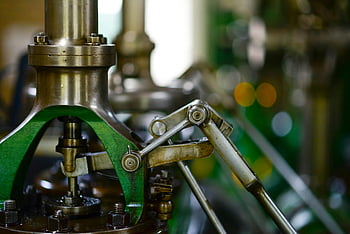 close-up photography, power tool, mechanical components, industrial setting, metal gears, levers, detailed view, machinery parts, industrial machinery, mechanical engineering, industrial equipment