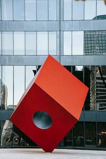 red cube sculpture, modern city square, Manhattan architecture, futuristic art, urban art, contemporary sculpture, public art installation, geometric sculpture, red art, modern sculpture, cityscape art