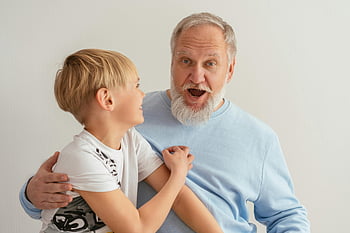 grandfather, grandson, happy moment, indoor, smiles, laughter, family bonding, joyful, multi-generational, togetherness, affectionate