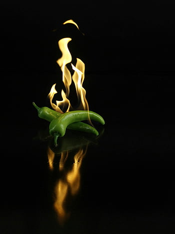 green chili, fire, flames, dark surface, reflective surface, chili peppers, dynamic image, green peppers, burning chili, spicy food, culinary art