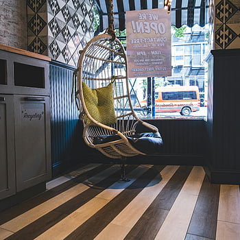wicker egg chair, hanging chair, modern cafeteria, bright cafe, patterned tiles, New York street, stylish chair, interior design, cafe decor, urban view, cozy seating