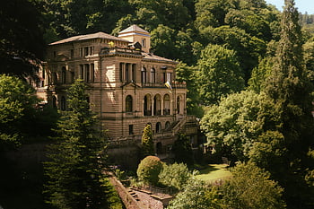 historical villa, lush forest, elegant architecture, serene setting, preserved architecture, greenery, villa surrounded by trees, classical architecture, tranquil landscape