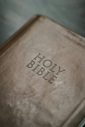 Holy Bible, antique Bible, close-up shot, Bible cover, detailed texture, religious book, vintage Bible, sacred text, leather texture, book design, holy scripture
