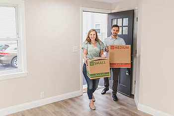 couple carrying boxes, new home, fresh start, moving day, cardboard boxes, joyful couple, moving in, home relocation, new beginning, moving boxes, couple moving