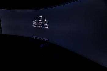 curved monitor, ChatGPT interface, low-light photography, technology focus, AI interface, screen close-up, modern monitor, digital display, artificial intelligence, tech setup, curved display