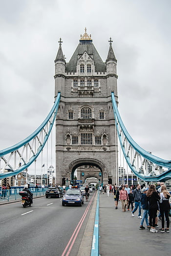 Tower Bridge, London, group of people, walking on bridge, iconic architecture, bustling scene, visitors, cityscape, urban view, landmark, travel destination