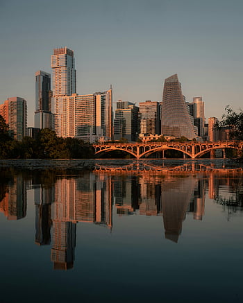 Austin skyline, river reflection, urban serenity, sunset view, Texas cityscape, bridge reflection, downtown Austin, skyscrapers at sunset, city river, Austin bridge, serene urban view