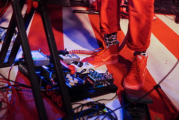 guitar pedal controllers, keyboard stand, live concert, musician, stage scene, pedal effects, vibrant stage, performance, music event, concert stage, live music