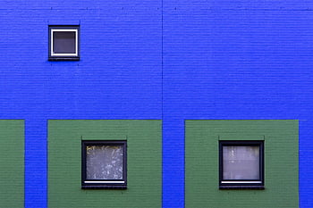 brick wall, colorful building, geometric pattern, framed windows, exterior architecture, modern building design, window patterns, building facades, minimalist architecture.