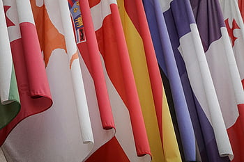 international flags, assorted flags, vibrant display, closely hanging, various flags, international symbols, colorful flags, global flags, hanging flags, assorted international flags, vibrant flags