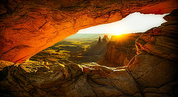 Mesa Arch, sunrise, rock formations, desert landscape, orange and brown cave, captivating view, natural arch, canyonlands national park, outdoor photography, scenic landscape, nature photography
