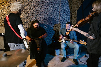 band practicing, diverse musicians, rehearsing, instruments, intimate recording studio, group of musicians, music rehearsal, studio setting, musical instruments, band members, collaborative music session