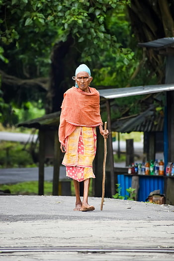 old woman, barefoot, walking, traditional wear, cane, rural area, senior woman, outdoor, village scene, elderly, barefooted