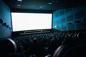 high-angle shot, people watching movie, theater, cinema audience, large screen, crowded cinema, movie theater, seated audience, indoor theater, film screening, movie viewing