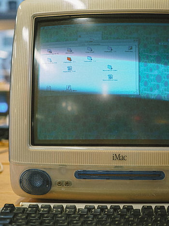 vintage iMac, close-up photo, old computer, retro vibe, desktop icons, nostalgic, classic iMac, vintage technology, old Macintosh, retro computer, iMac display