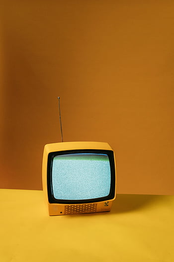 vintage yellow television, static screen, orange backdrop, nostalgic vibe, classic yellow TV, retro TV, vintage electronics, mid-century design, analog television, yellow TV, static noise