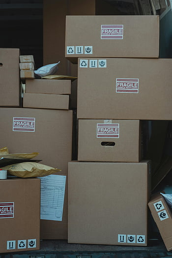 stacked carton boxes, fragile boxes, shipping boxes, storage boxes, cardboard boxes, handle with care, vertical stack, close-up photo, shipping and storage, fragile handle with care, box labels