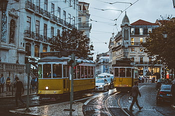 Lisbon, trams, charming streets, urban life, transportation, dusk, scenic view, cityscape, tram tracks, people walking, historic buildings