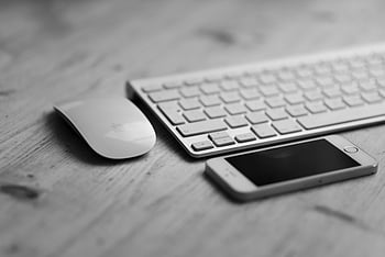 Apple Magic Mouse, Apple Magic Keyboard, smartphone, desk setup, tech accessories, black and white, minimalist workspace, computer peripherals, wireless devices, office gadgets, modern technology