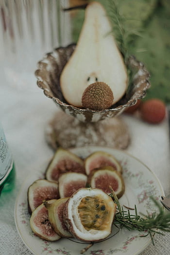 fresh fruit, figs, sliced pear, rosemary garnish, healthy eating, platter arrangement, table setting, fresh figs, rosemary, healthy food