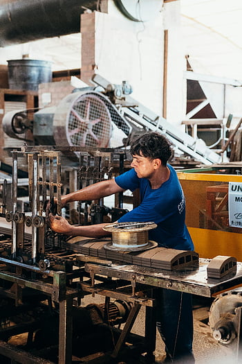 industrial worker, factory machinery, manufacturing, industrial products, factory worker, machinery operation, industrial setting, manufacturing process, factory equipment, industrial environment, worker operating machinery