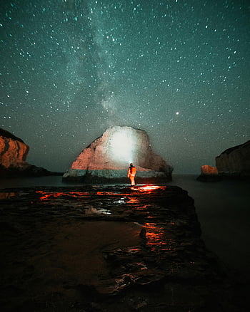 Milky Way, Shark Fin Cove, night scene, lone explorer, starry sky, body of water, rock formation, night photography, coastal landscape, stargazing, night adventure