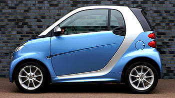 Blue Smart Fortwo, side view, modern blue smart car, compact design, brick wall, smart car, blue car, urban vehicle, small car, city car, side profile