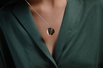 silver pendant, necklace, green blouse, stylish jewelry, close-up, classy look, silver jewelry, pendant necklace, fashion accessory, elegant style, women's jewelry