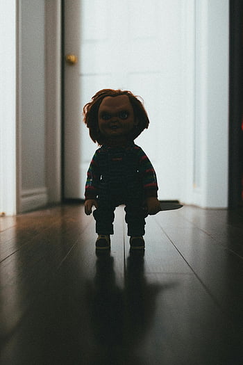 horror movie doll, knife, eerie silhouette, dark hallway, spooky atmosphere, Chucky, horror doll, scary doll, creepy doll, horror film, spooky doll