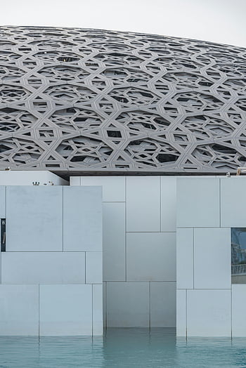 modern building, geometric elements, geometric patterned dome, water reflection, contemporary architecture, architectural design, modern structure, geometric shapes, dome structure, water feature, urban landscape