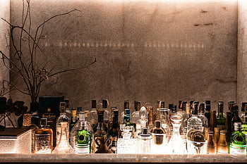 liquor bottles, sophisticated bar, upscale ambiance, bar setup, various bottles, elegant bar, bar display, bar decor, bar arrangement, bar lighting, bar scene
