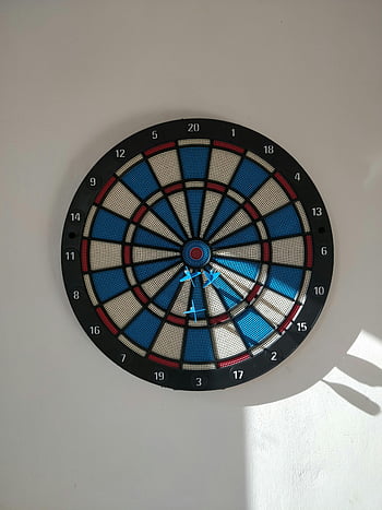 board, concrete wall, colorful dartboard, wall-mounted dartboard, darts, bullseye, strategic placement, indoor game, recreational activity, wall decoration, dart playing