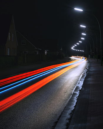 time lapse, night photography, light trails, city street, long exposure, vibrant lights, motion capture, speed effect, urban night scene, street lights, night road